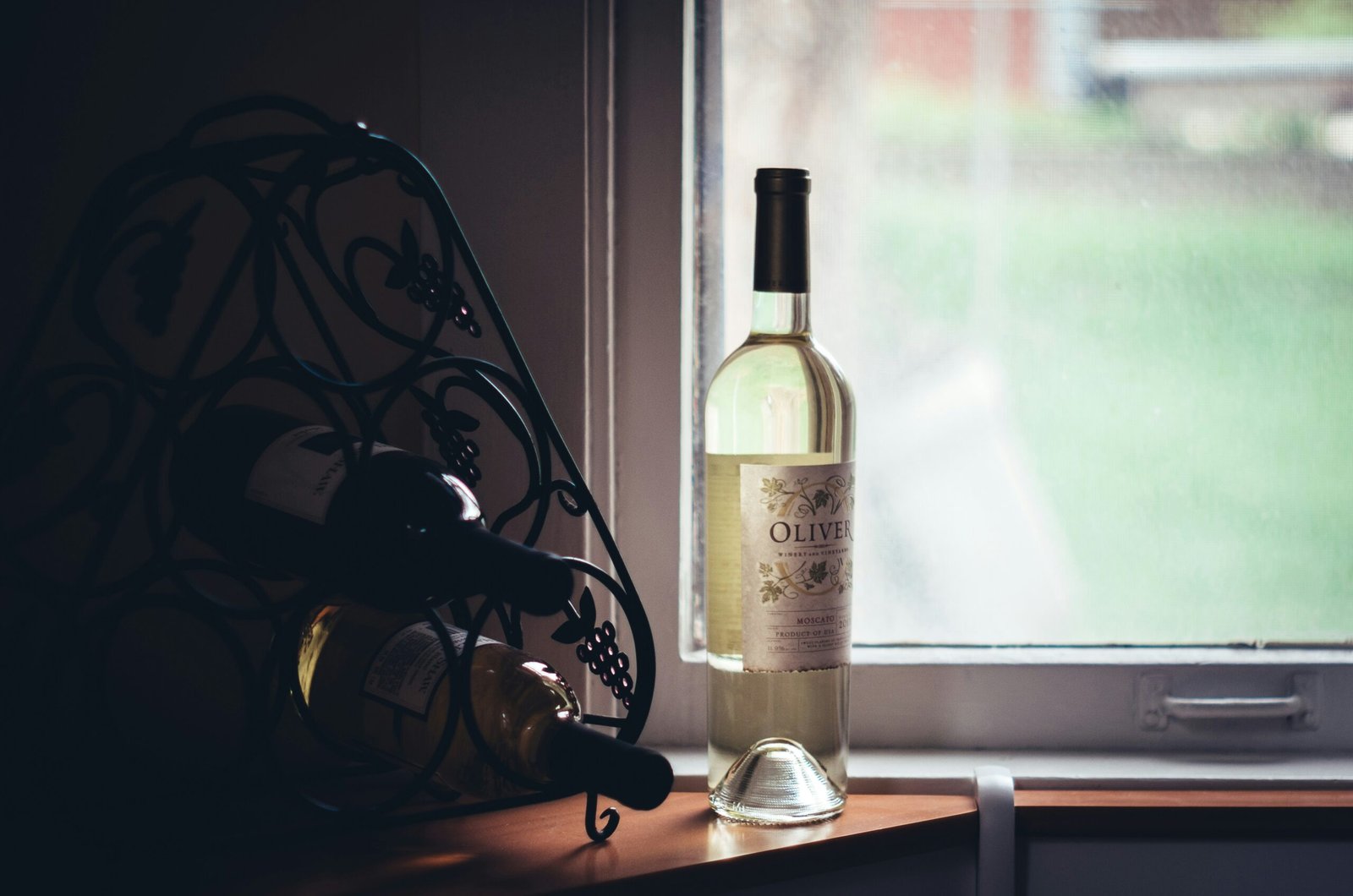 clear glass bottle near window